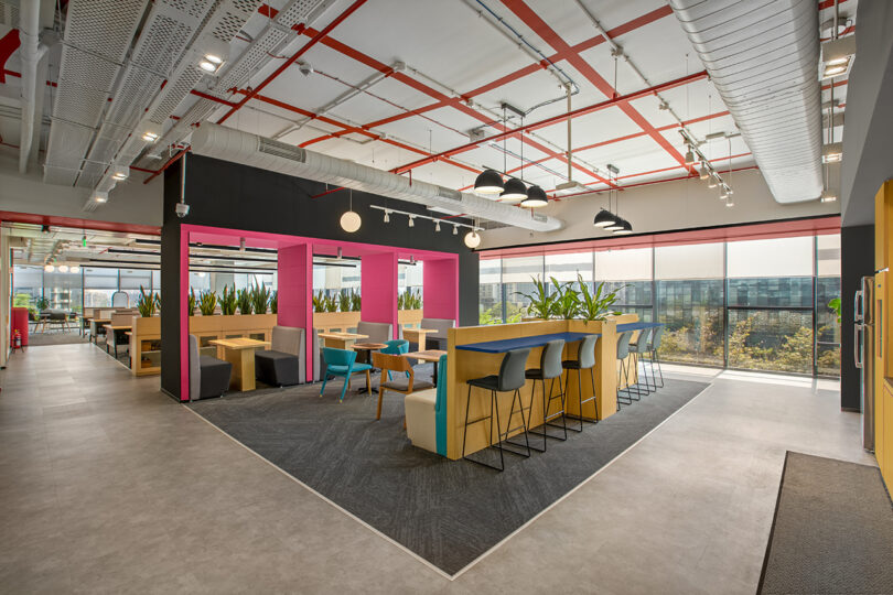 interior commercial gathering space in hot pink, yellow, and blue