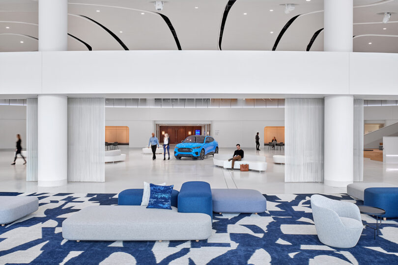 white and blue commercial interior space with seating an a blue car