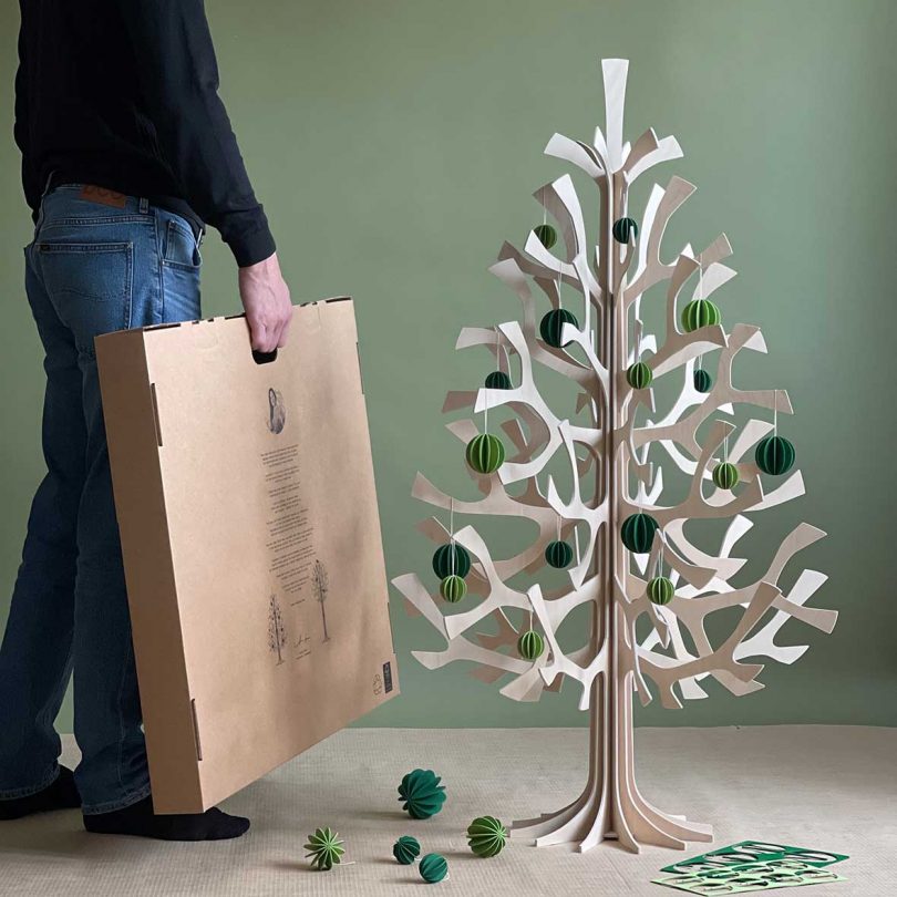 120cm wooden tree with green ornament with lower half of man holding box