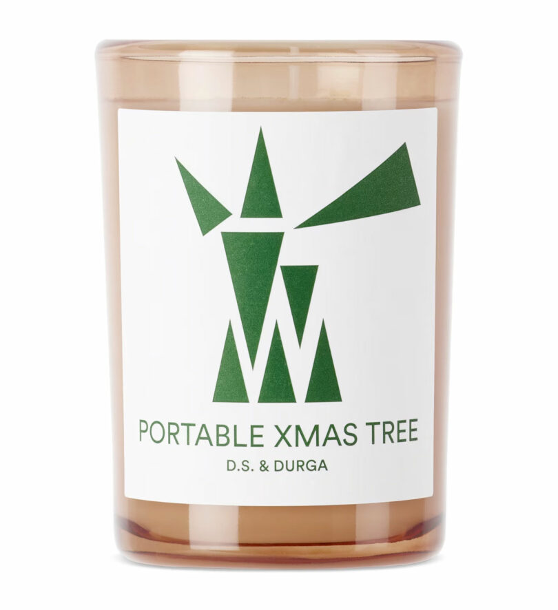 closeup of christmas candle with geometric green design on label