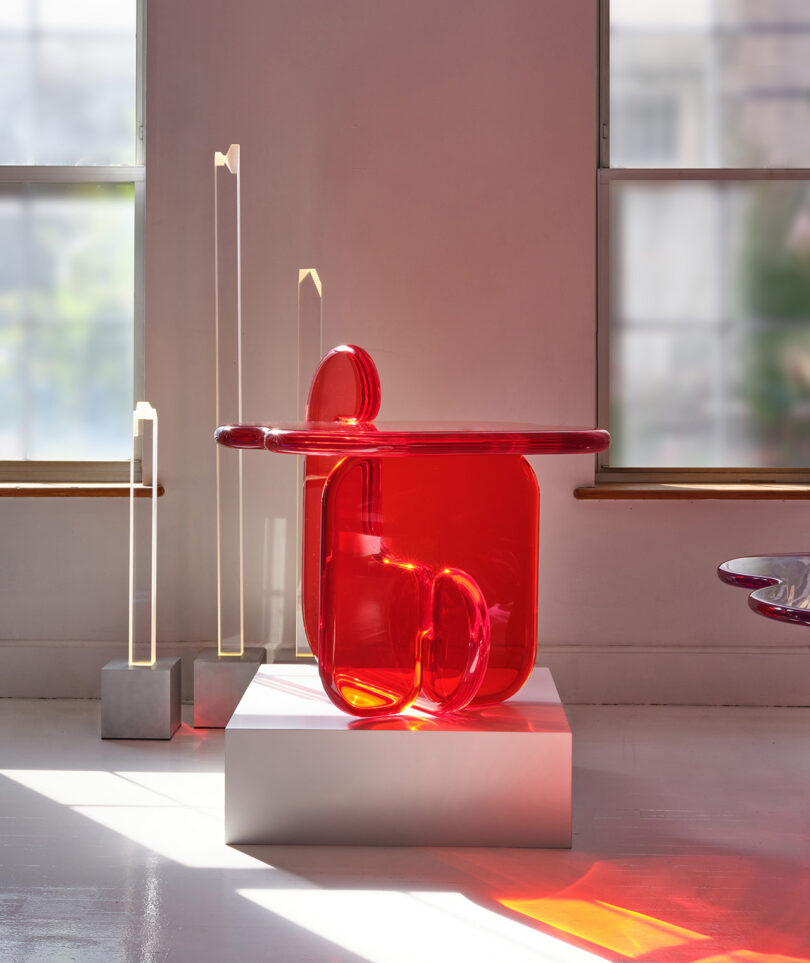 red resin side table on display