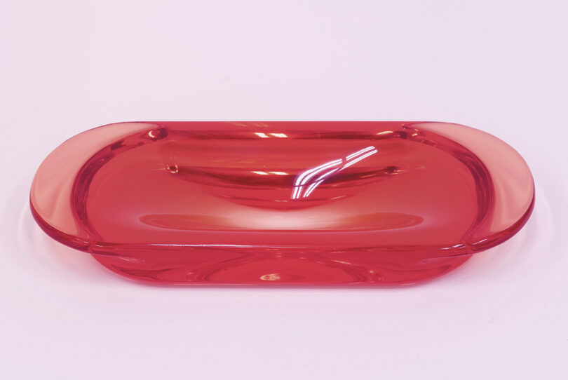 red resin trinket dish on a pink background