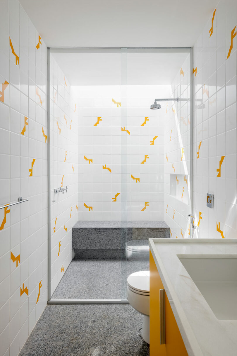 modern bathroom with white and yellow accent tile