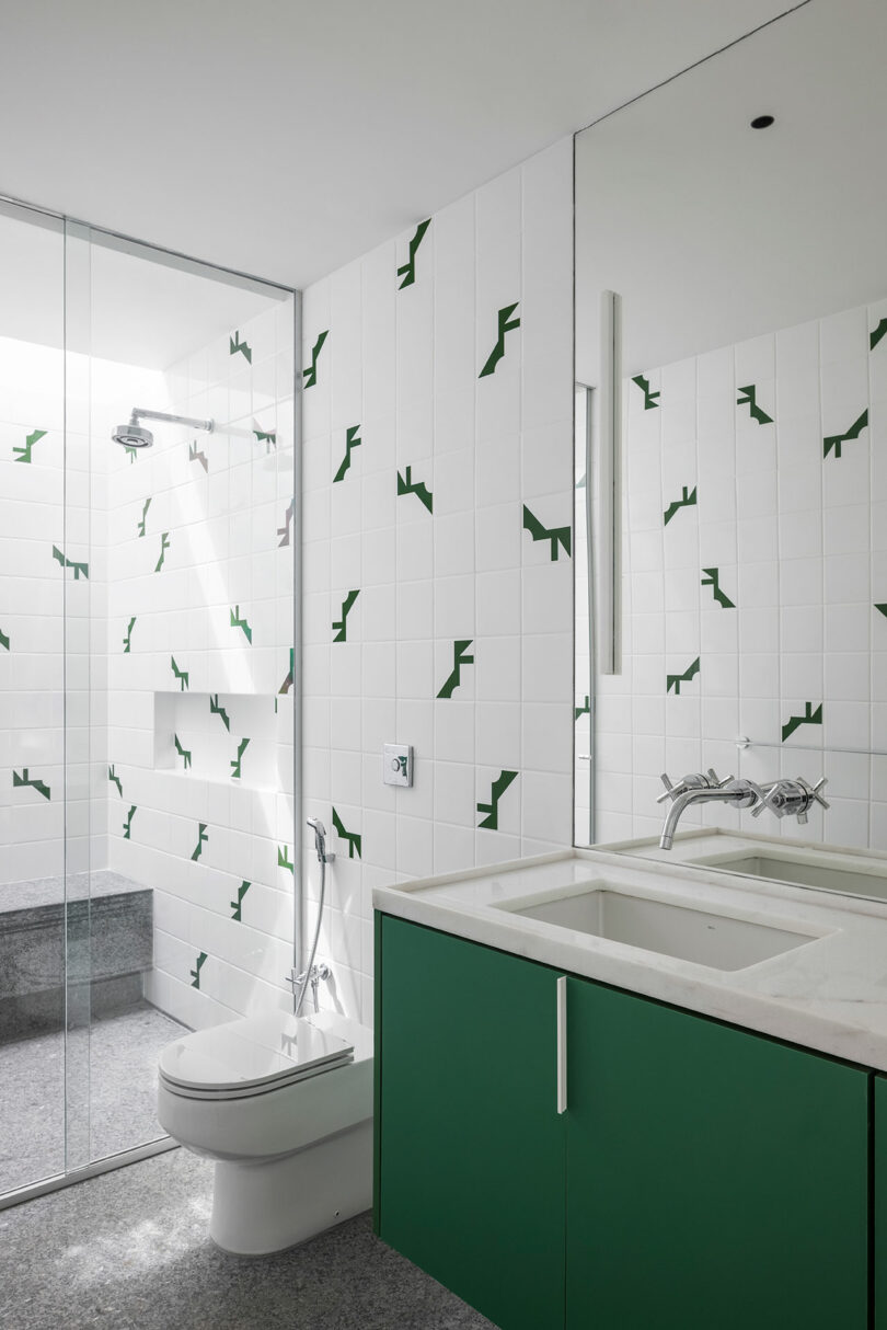 modern bathroom with white and green accent tile
