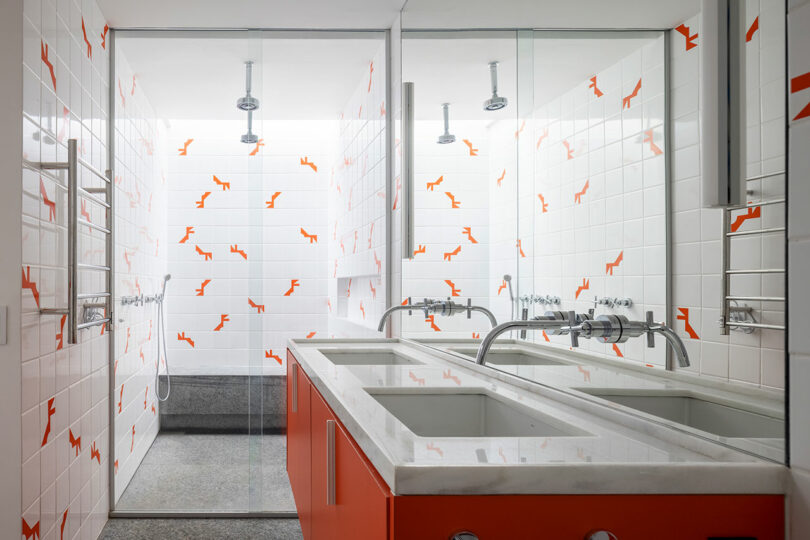 modern bathroom with white and orange accent tile
