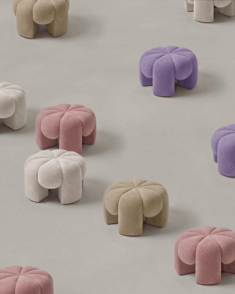 group of white, beige, purple, and pink ottomans shaped like flowers