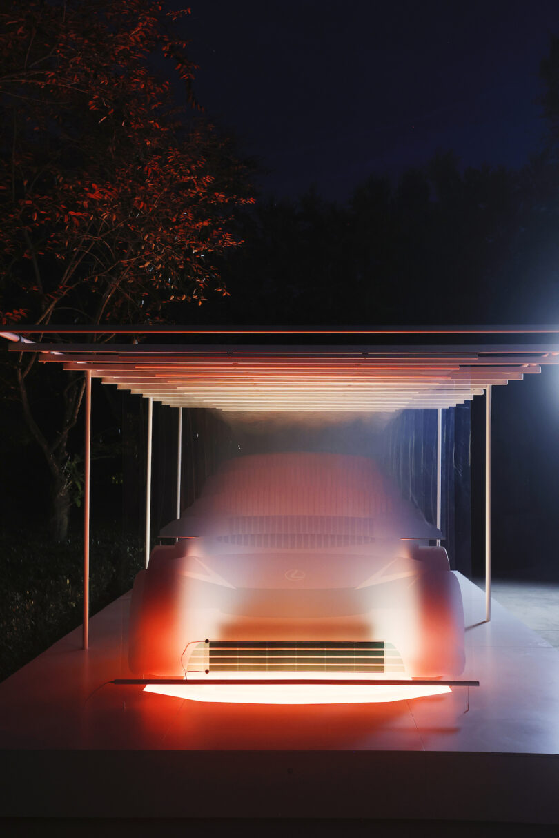 car installation on white platform lit at night