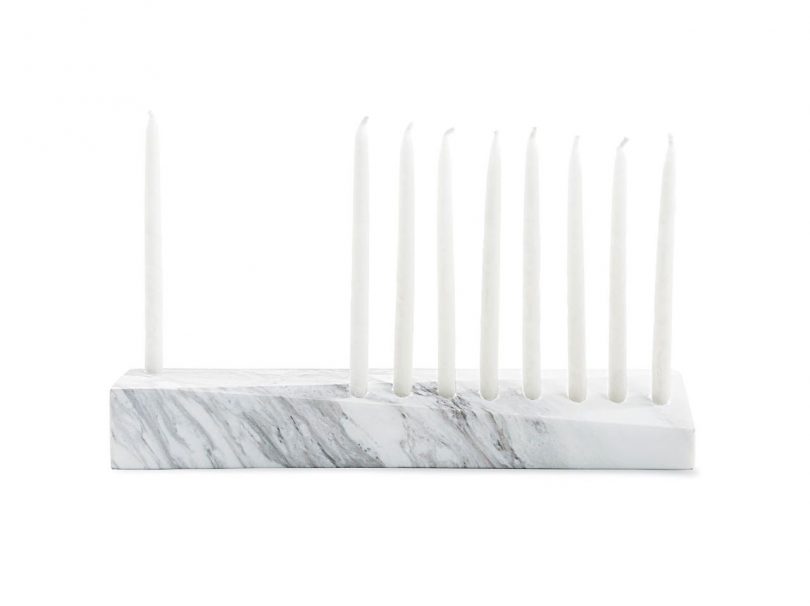 light grey and white marble menorah with some candles