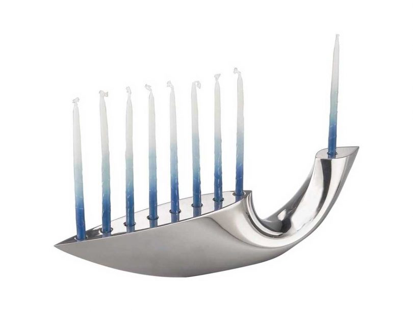 silver sculptural menorah with blue and white candles