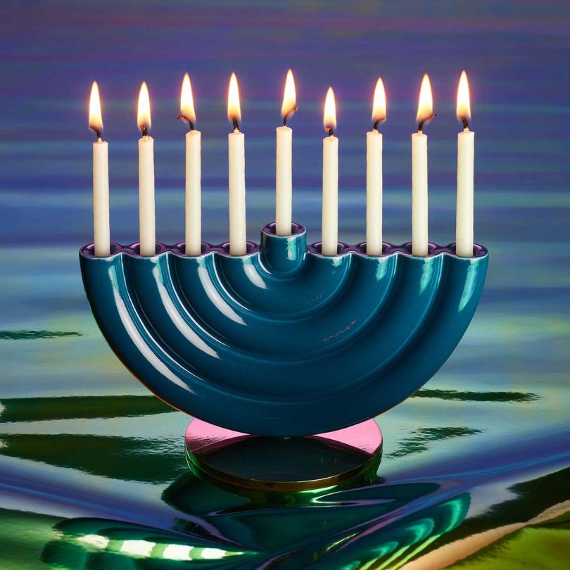 modern rainbow menorah with gradient background and candles lit
