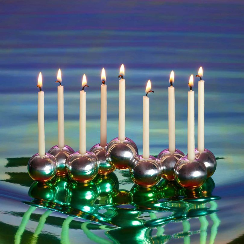 modern metal bubble menorah with gradient background and candles lit
