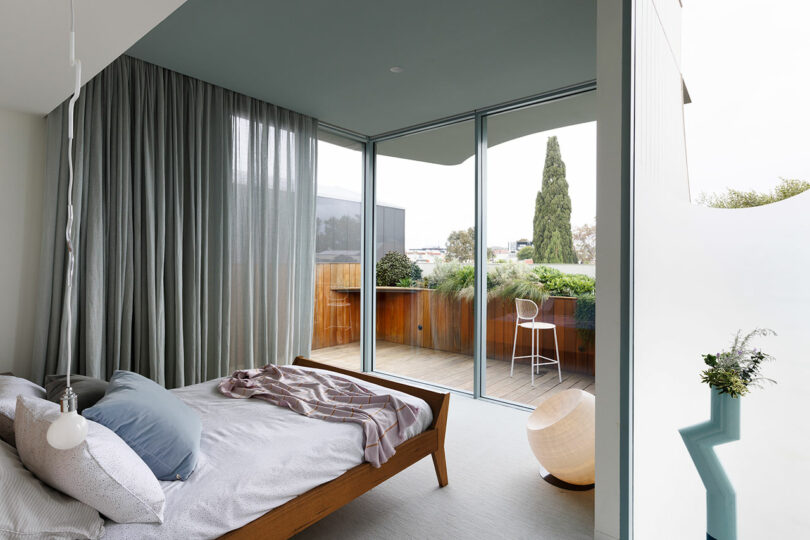 angled view of modern bedroom looking out to floor to ceiling sliding doors