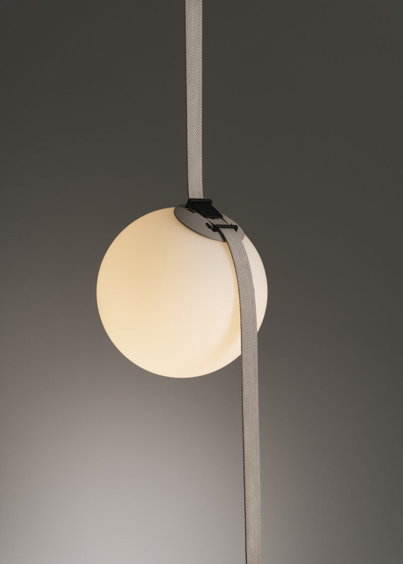 detail of adjustable lighting system that uses "belts" to add and subtract pendants