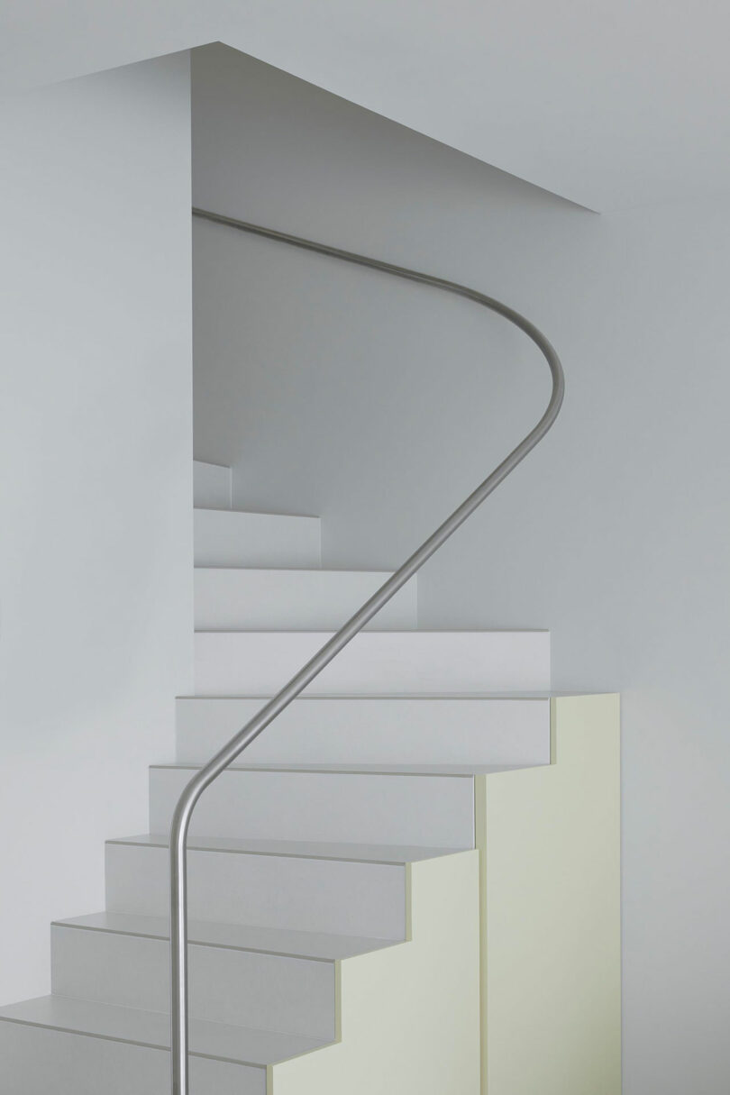 partial view of partially open white staircase with pale yellow on outside