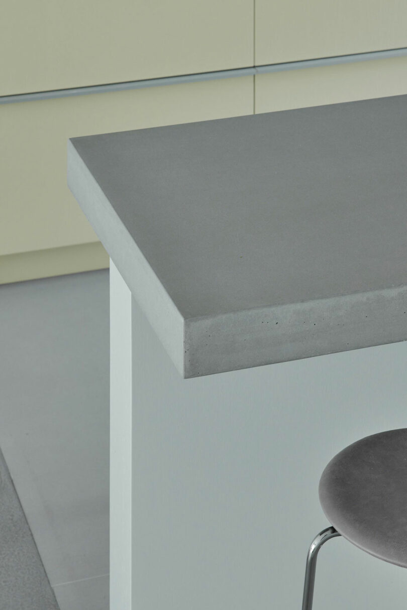 closeup angled view of gray concrete countertop bar in modern kitchen